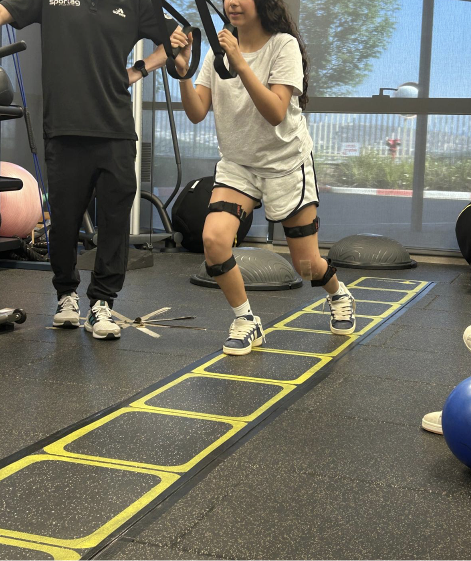 Athlete in rehab wearing TropX knee sensors